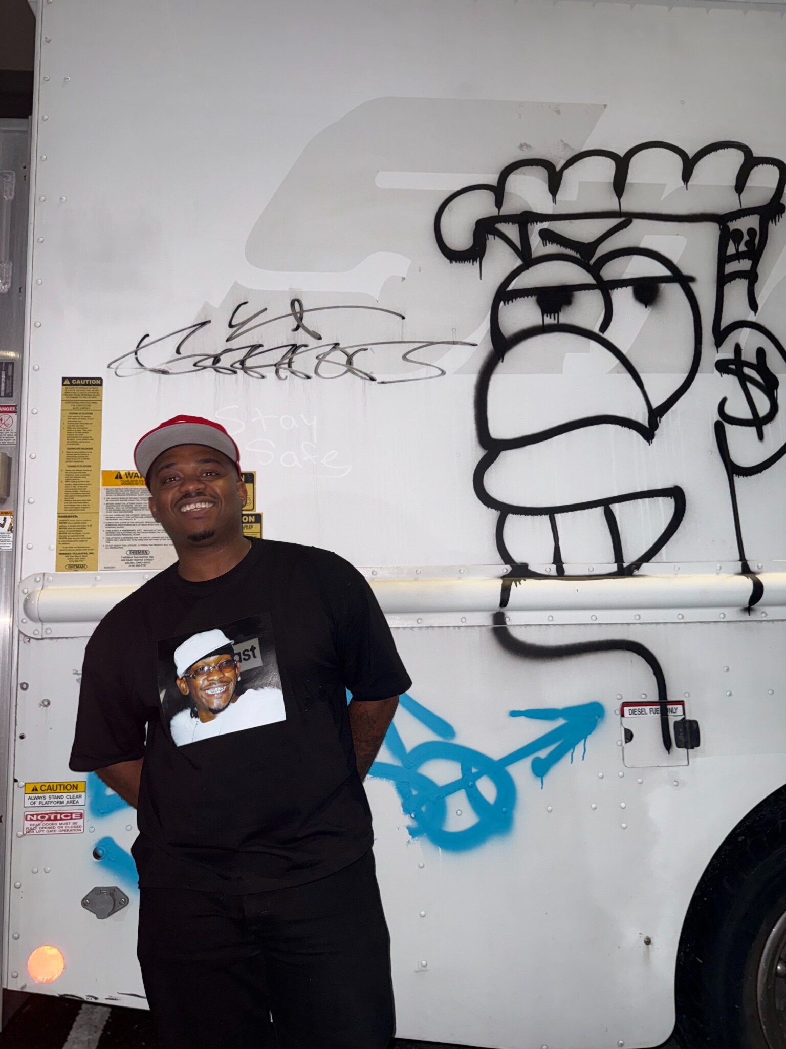 Christian Alexander in front of a graffiti-covered truck